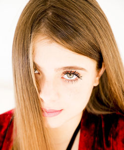 Portrait of young woman against white background