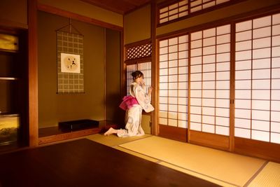 Woman standing by window