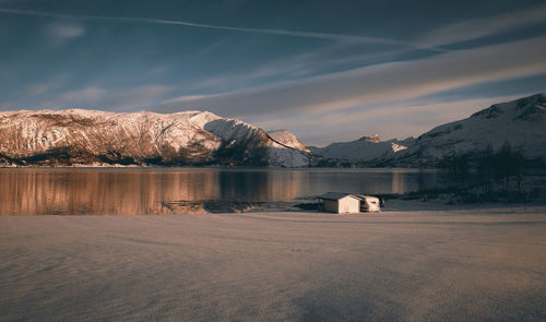 Scenic view of lake and mountains against sky