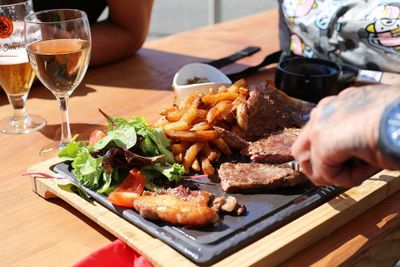 Close-up of hand eating food at table