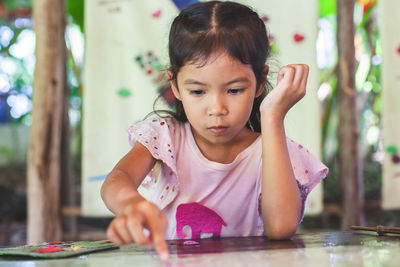 Close-up of cute girl making artwork at workshop