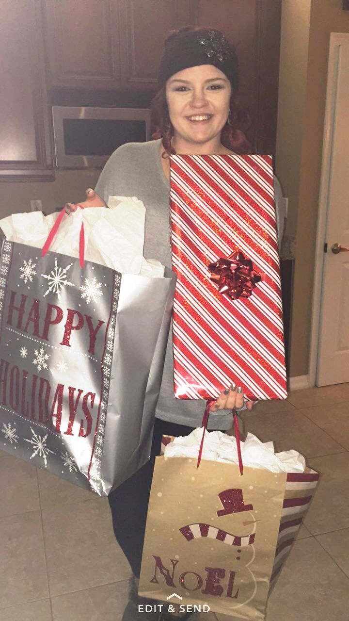 smiling, looking at camera, happiness, full length, portrait, one person, christmas, cheerful, adult, enjoyment, indoors, people, lifestyles, shopping bag, celebration, one woman only, christmas present, leisure activity, only women, excitement, adults only, women, gift, day