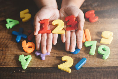 Low section of person with toys on table