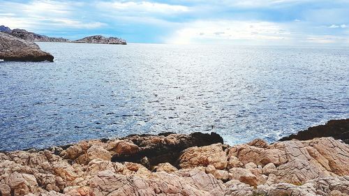 Rocks on beach against sky