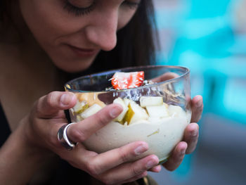 Close-up of woman holding fruits in bowl