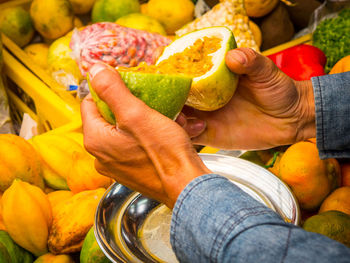 Close-up of man holding fruit