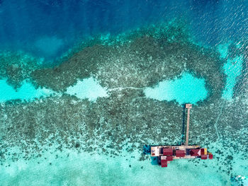 Aerial view of water chalet in egang egang near bum bum island during sunrise.