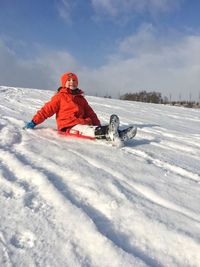 Person in snow on field against sky