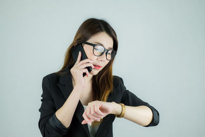 Young woman wearing mask against white background