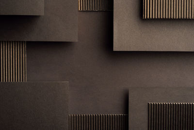 Geometric black background made of corrugated cardboard and paper