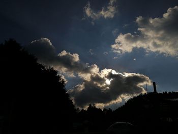 Low angle view of silhouette trees against sky