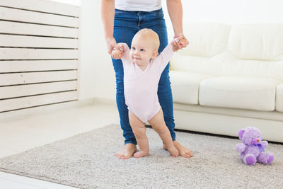 Mother playing with daughter at home