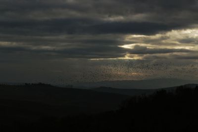 Scenic view of silhouette landscape against sky at sunset