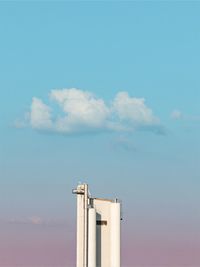 Low angle view of smoke stack against sky