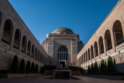 Low angle view of building against blue sky