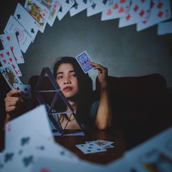 Portrait of teenage girl playing at table