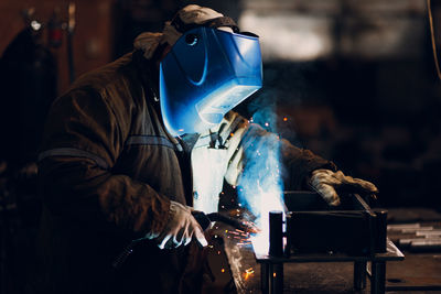 Rear view of man working in workshop