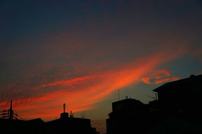 Silhouette of built structure against dramatic sky