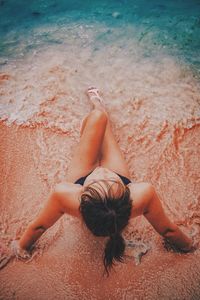 High angle view of woman relaxing on beach