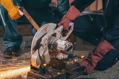 Low angle view of man working on metal