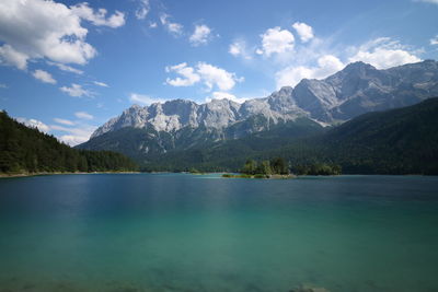 Scenic view of lake and mountains against sky