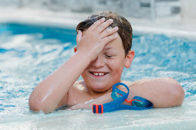 Close-up of smiling boy in swimming pool