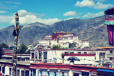 Low angle view of mountain range against cloudy sky