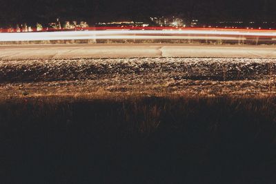 View of illuminated road at night