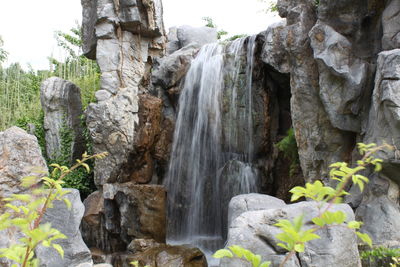 Low angle view of waterfall in park