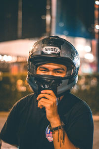 Portrait of man standing on street at night