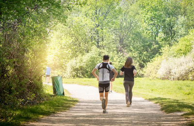 Rear view of couple walking on footpath