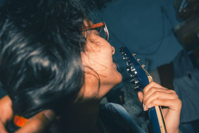 High angle view of woman playing guitar