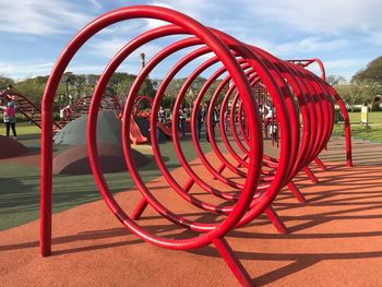 Close-up view of red wheel against sky