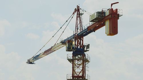 Low angle view of crane against sky