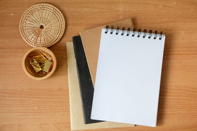 Directly above shot of note pad and book on table