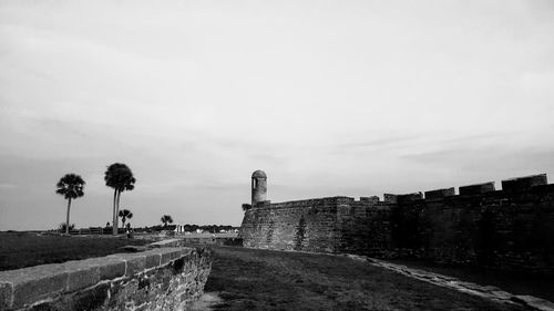 Walkway by building against sky