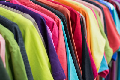 Full frame shot of colorful shirts hanging on coathangers