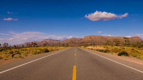 Surface level of empty road against sky