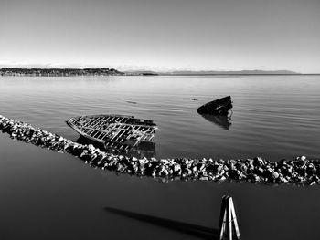 High angle view of groyne in sea against sky