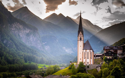 Panoramic view of buildings against cloudy sky