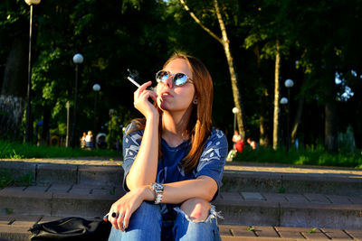 Young woman sitting in park