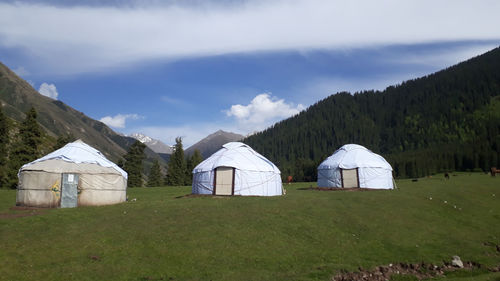 Built structure on field against sky