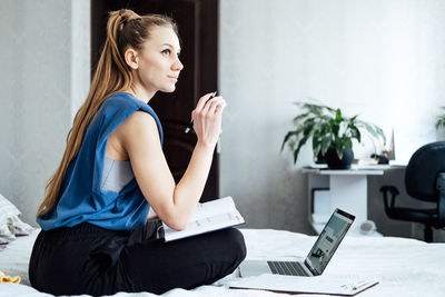 Job interview, finding new job. young woman writing in planner diary notes about job interview