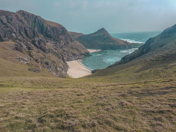 Scenic view of sea and mountains against sky