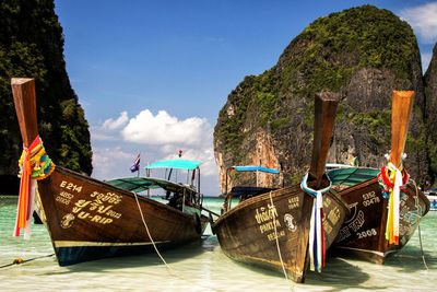 Boats moored on sea against sky