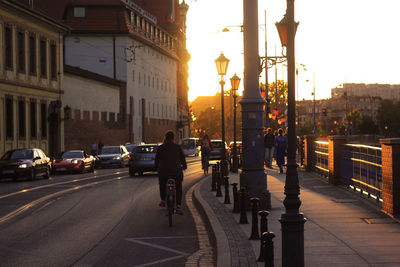 People on city street at sunset