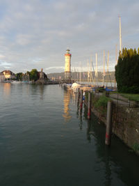 Scenic view of river by buildings against sky