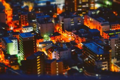 High angle view of illuminated buildings in city at night