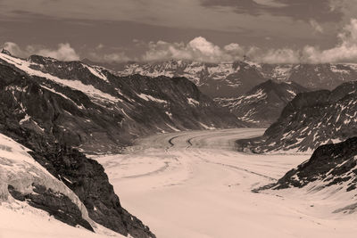 Scenic view of glacier and mountains against sky