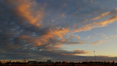 Silhouette city against sky during sunset